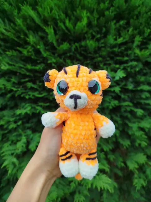 tigre au crochet dans une main